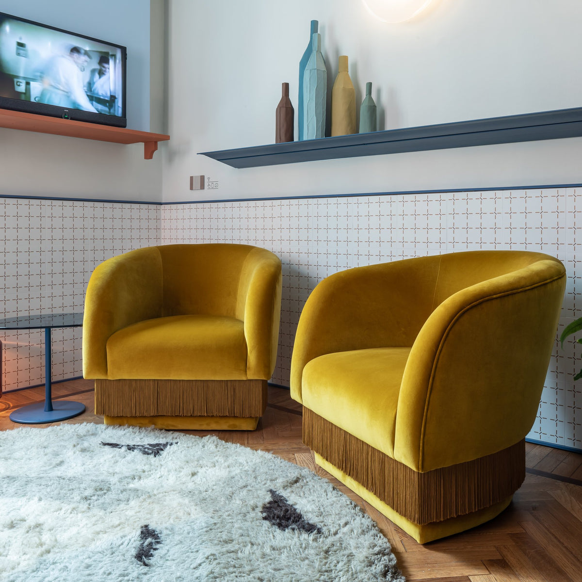 La Folie Armchair pair in mustard velvet in a lounge with a shag rug