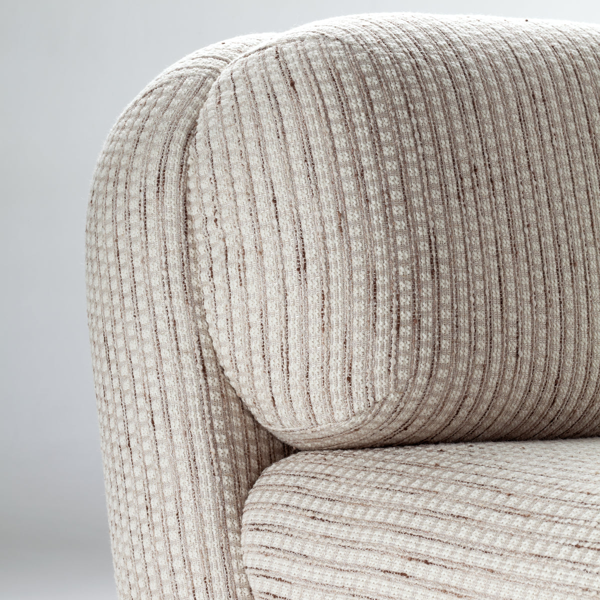 Mood Armchair close-up of the rounded back cushion in striped weave