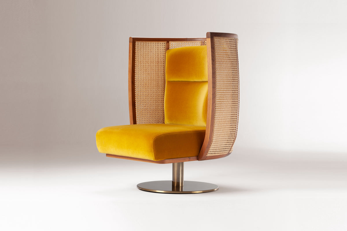 Egoista Armchair in mustard yellow velvet, three-quarter view on a grey backdrop