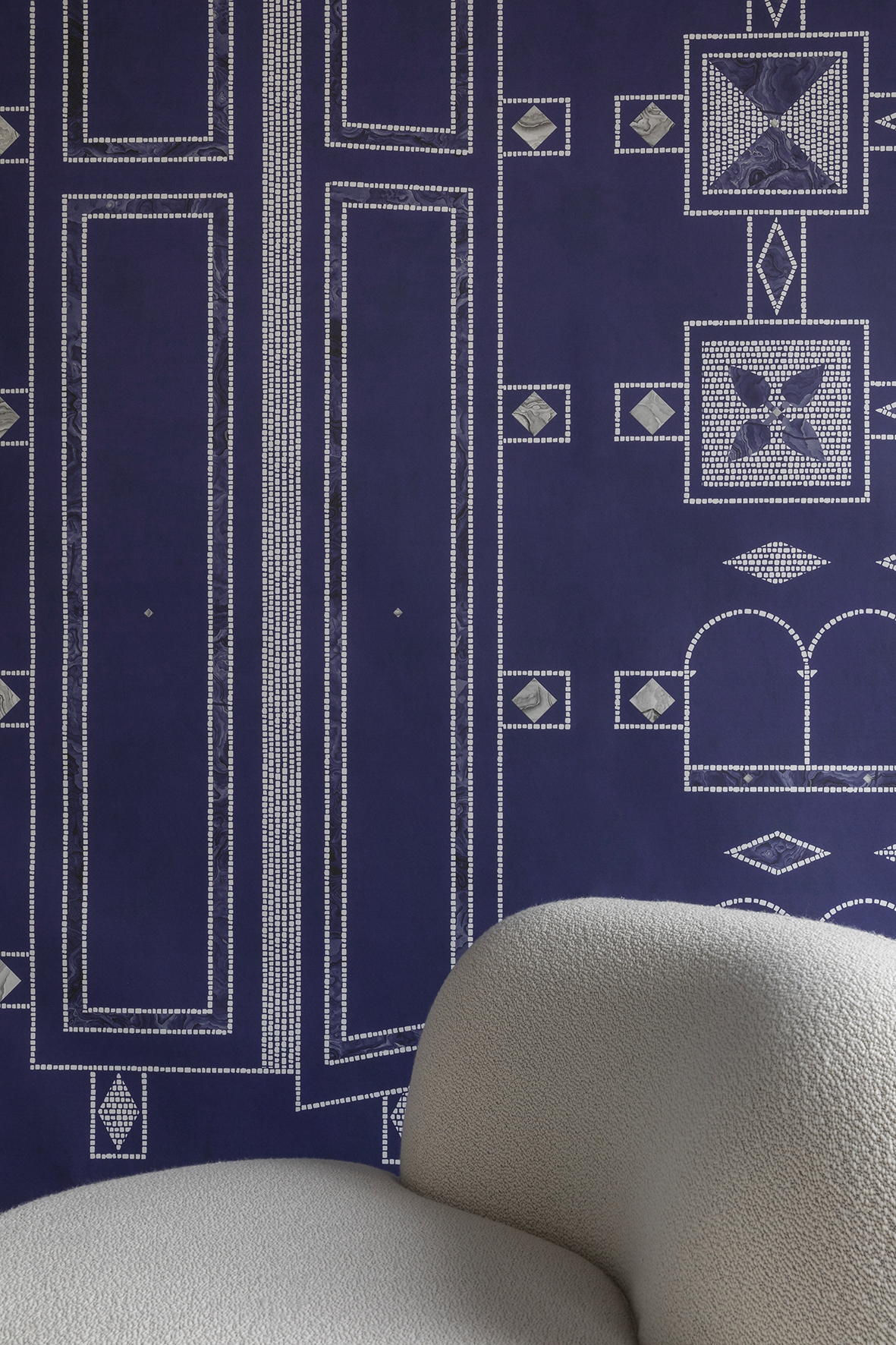 B-15 Z Lounge Chair backrest detail in ivory bouclé against a navy patterned wall