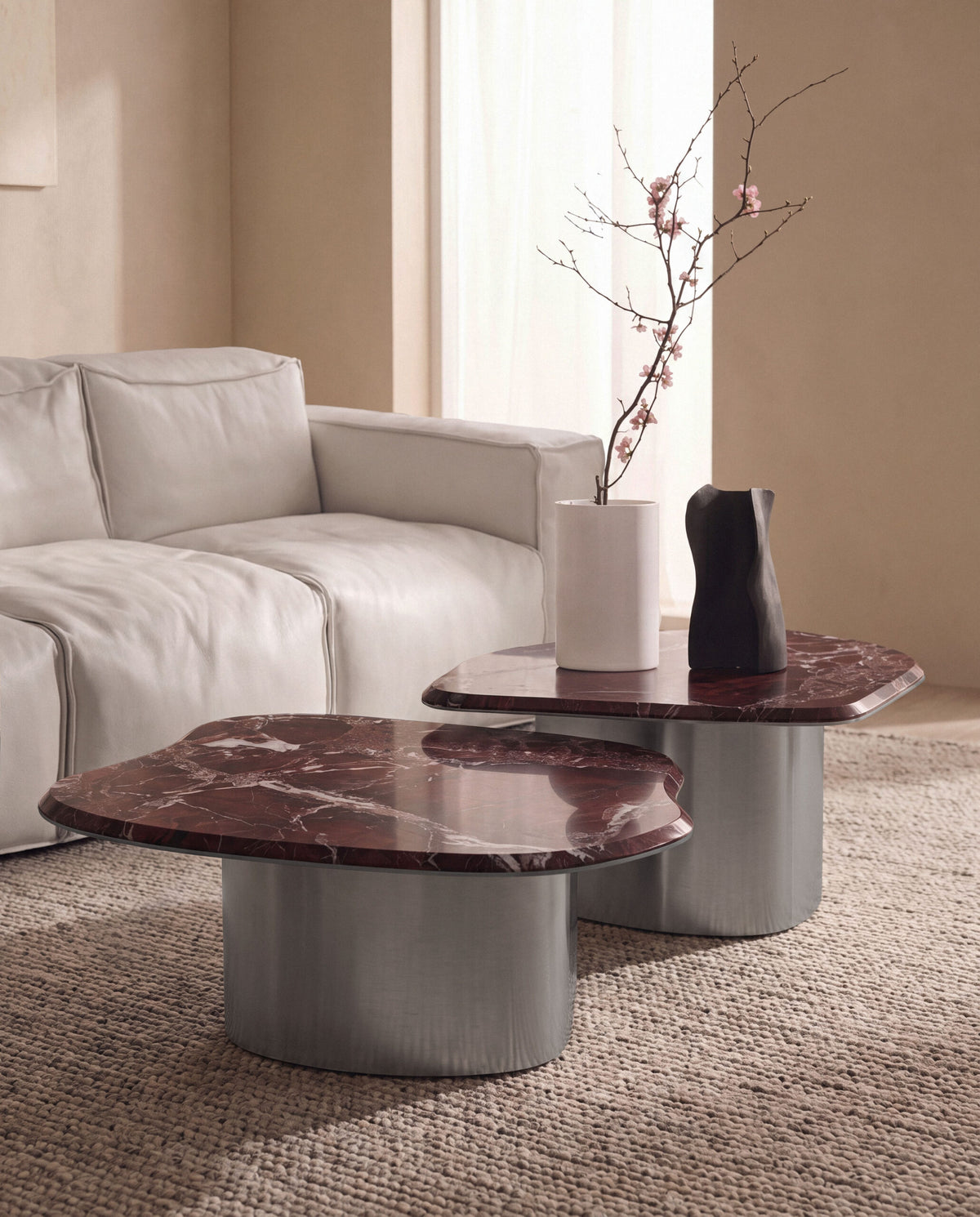 Fragment Coffee Tables in red marble before a white leather sofa