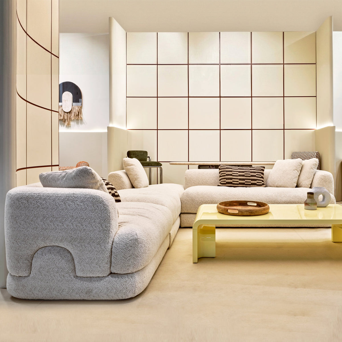 Mosaico Sectional Sofa – Composition 1 in grey bouclé in a living room with a yellow coffee table
