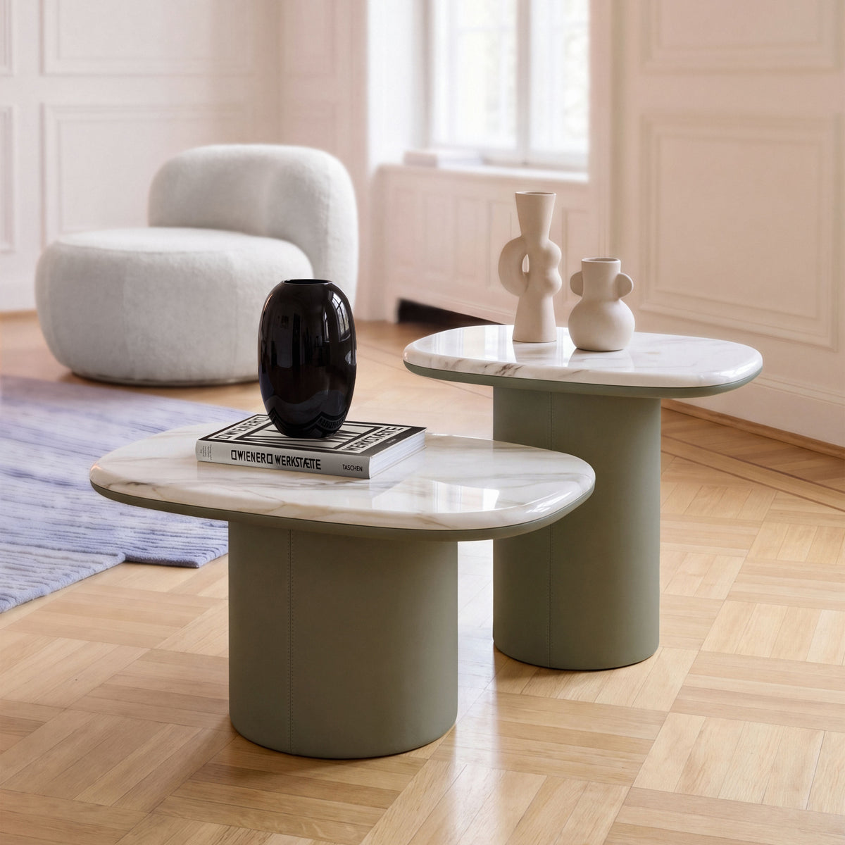 Gemini Soft Hex Side Tables pair with sage bases in a parquet living room with a bouclé chair