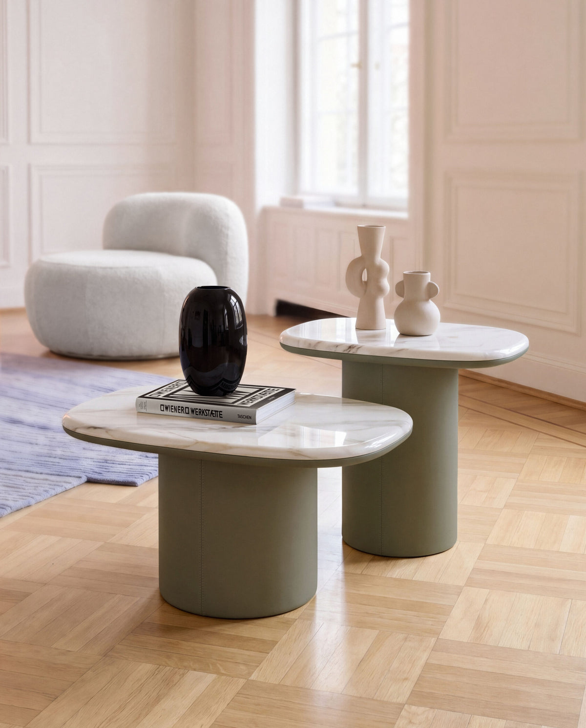 Gemini Soft Hex Side Tables styled with vases and books beside a white bouclé chair