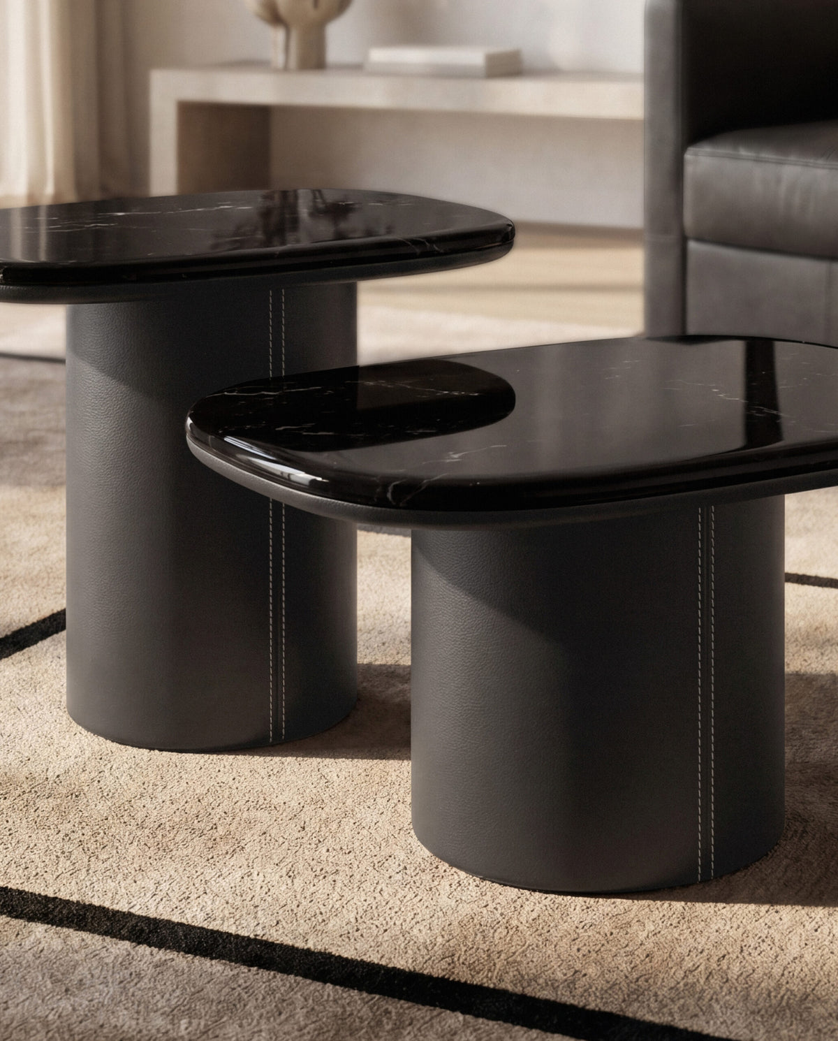 Gemini Soft Hex Side Tables pair in glossy black with dark bases on a rug