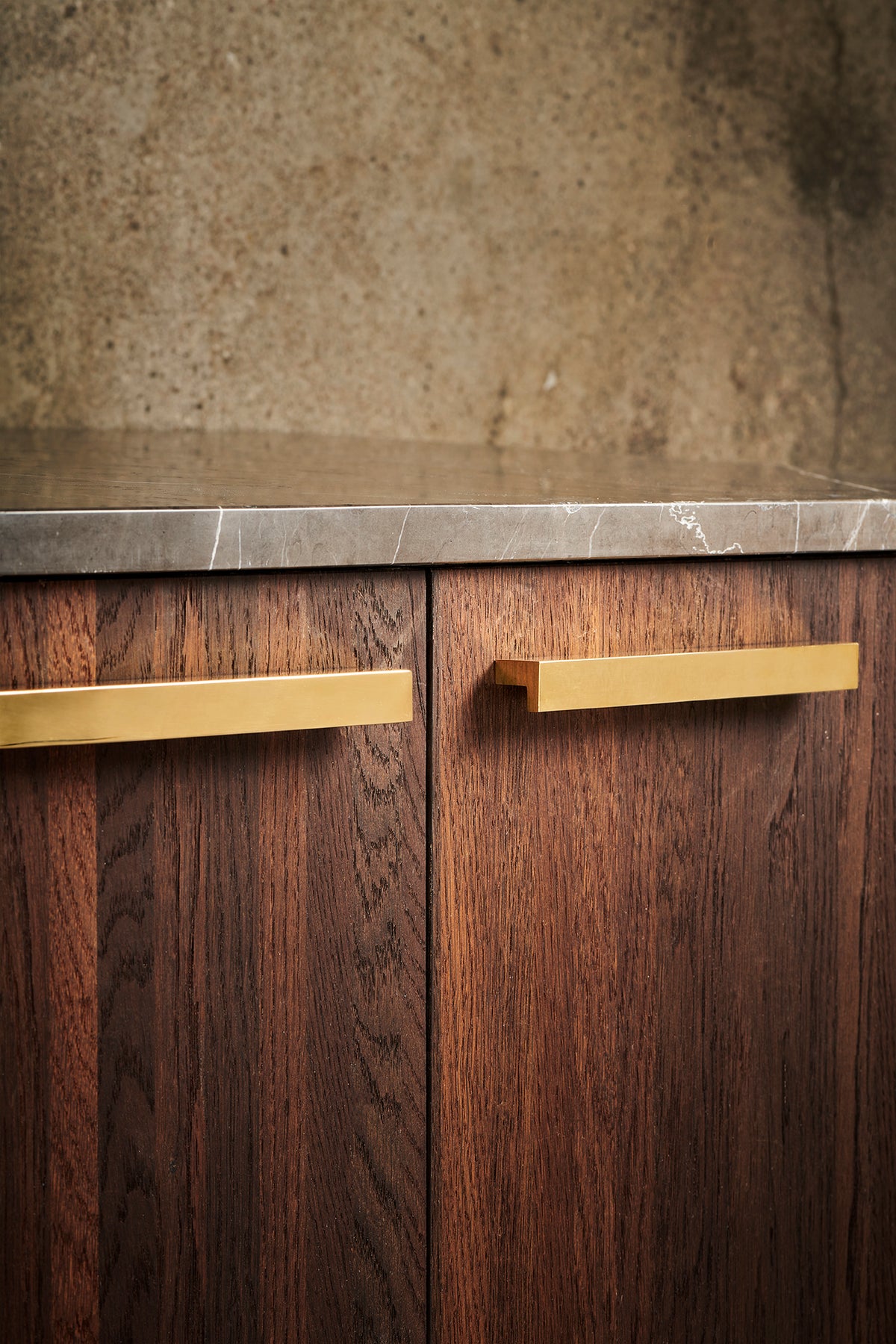 Get a Grip 2 cabinet handles in polished brass on a walnut cabinet by Maison Burgos