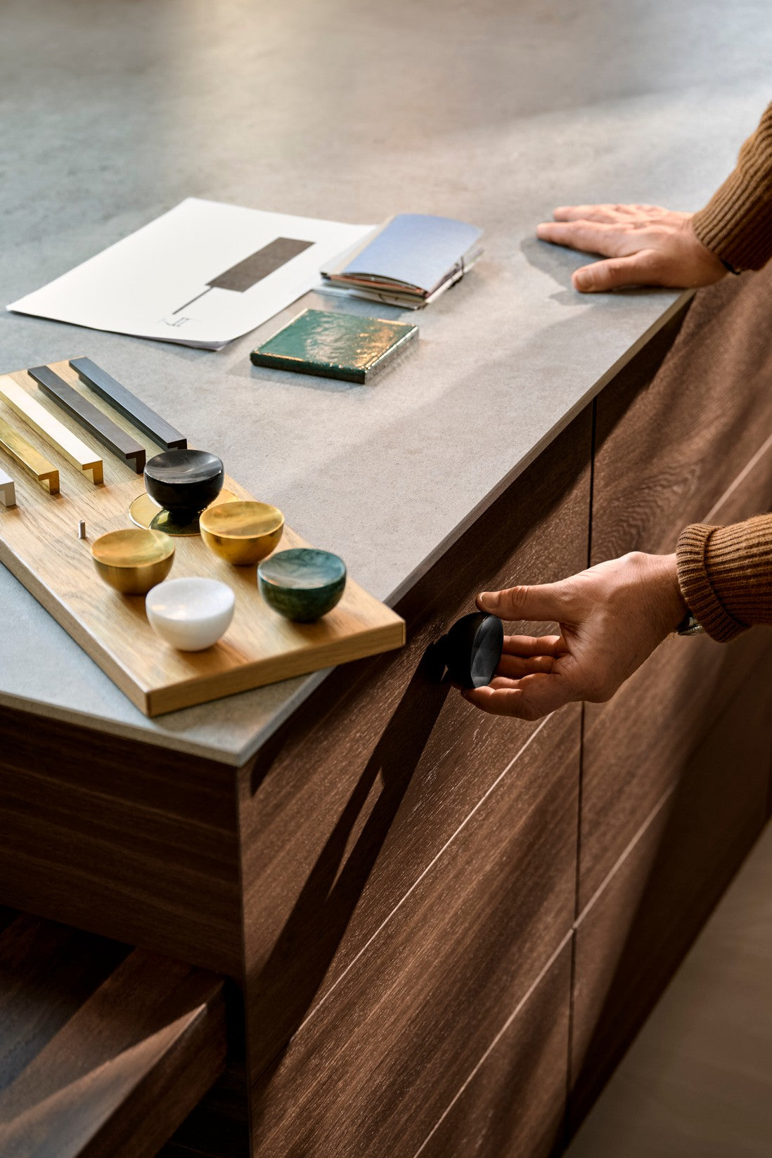 Get a Grip knob and handle finish samples on a walnut cabinet by Maison Burgos