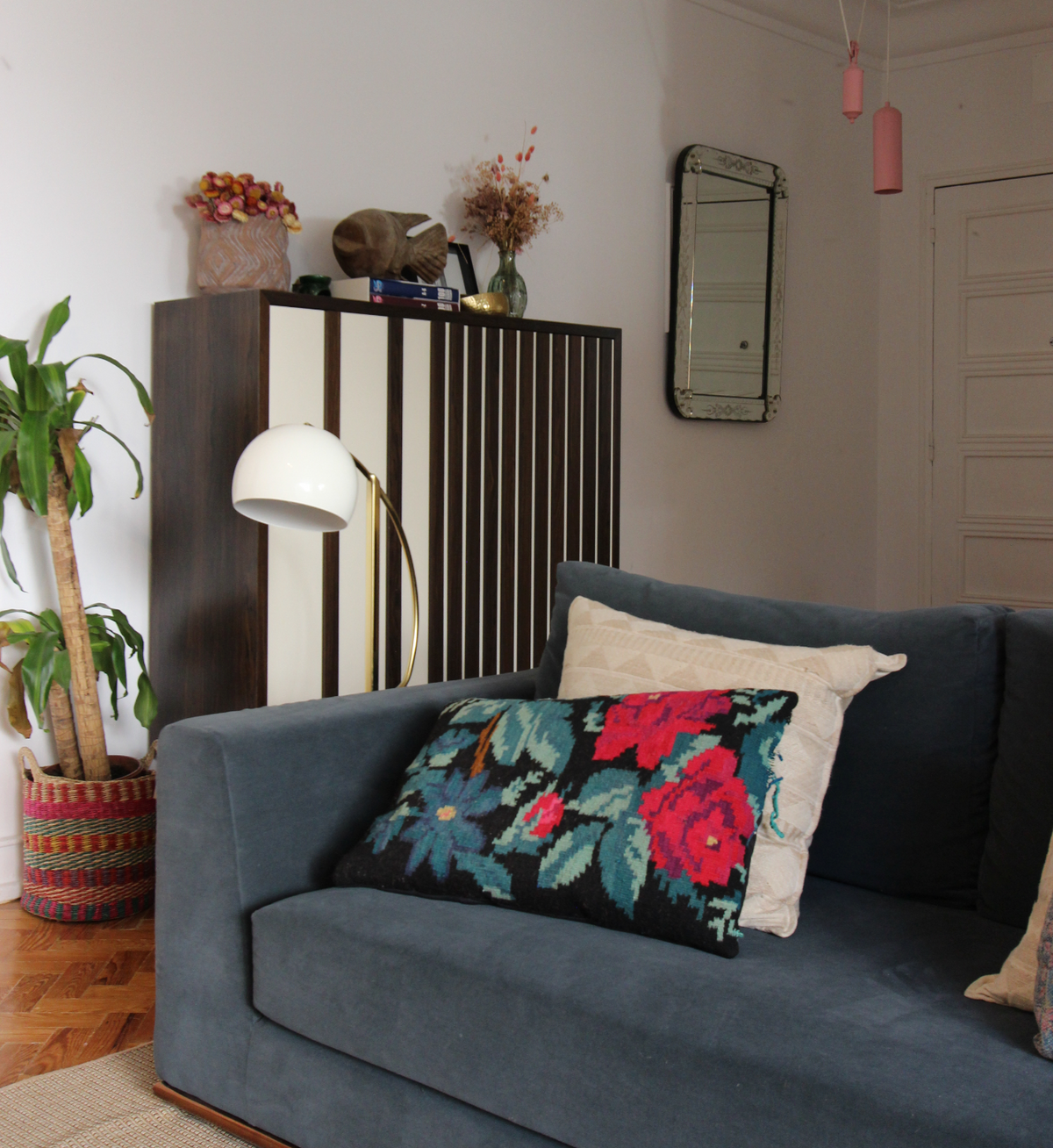 Go Bar Cabinet with ivory and dark wood striped doors beside a blue sofa