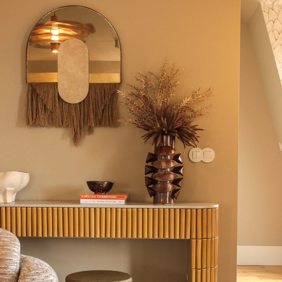 Souk Ecru Mirror Cream above a ribbed console with dried flowers in a warm hallway