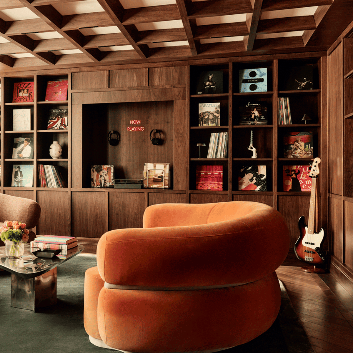 Malibu Curved Sofa in rust velvet in a wood-panelled library room