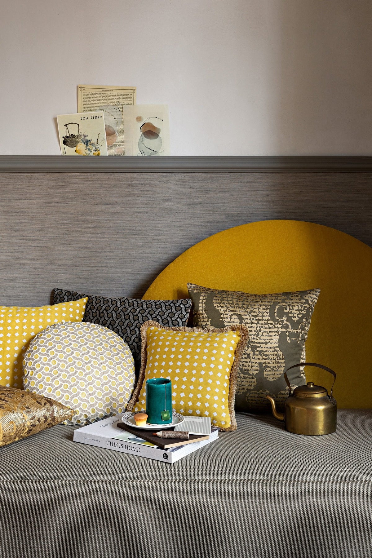 Horizon Sofa with mustard backrest, styled with patterned pillows and a brass kettle