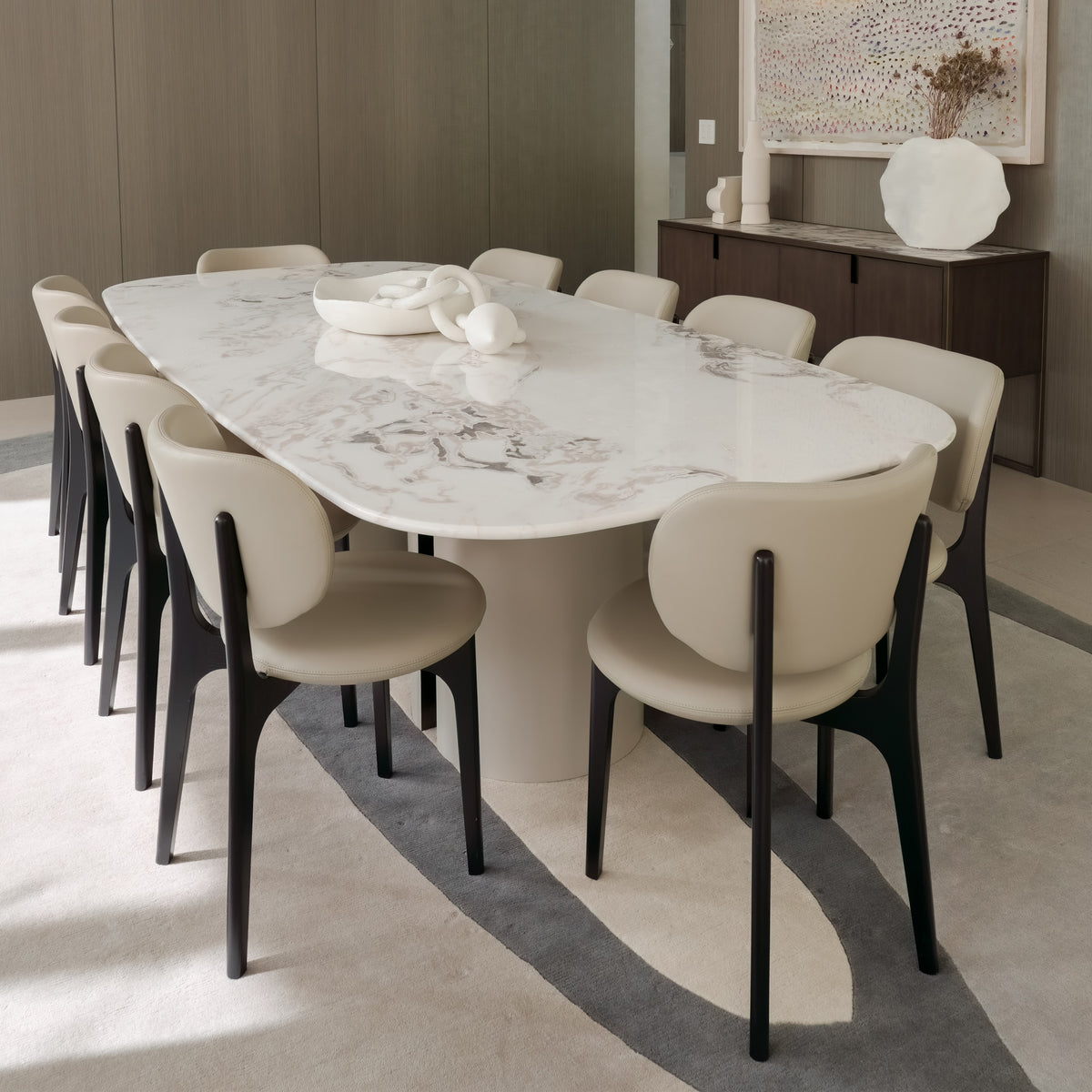 Horus Marble Dining Table in white marble set with beige chairs, closer view