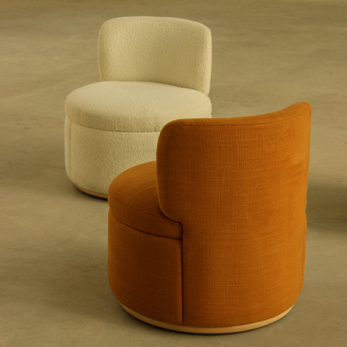 Mimi Swivel Lounge Chairs in cream and rust, close view of the curved backs