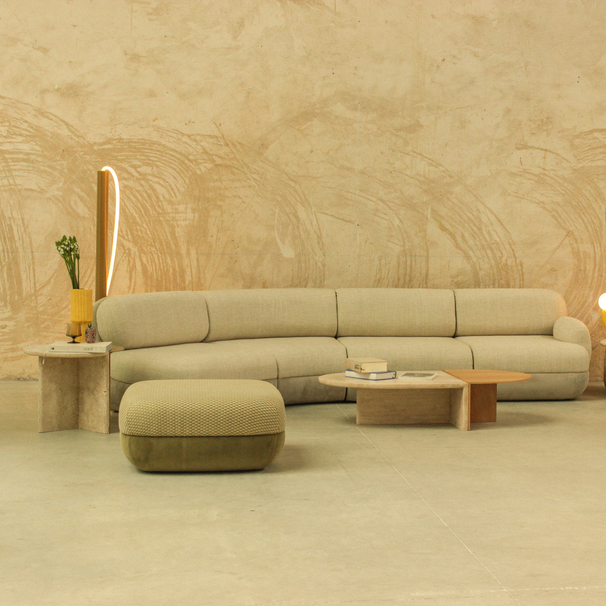 Duplex Coffee Table in a lounge with a curved olive sofa and matching ottoman