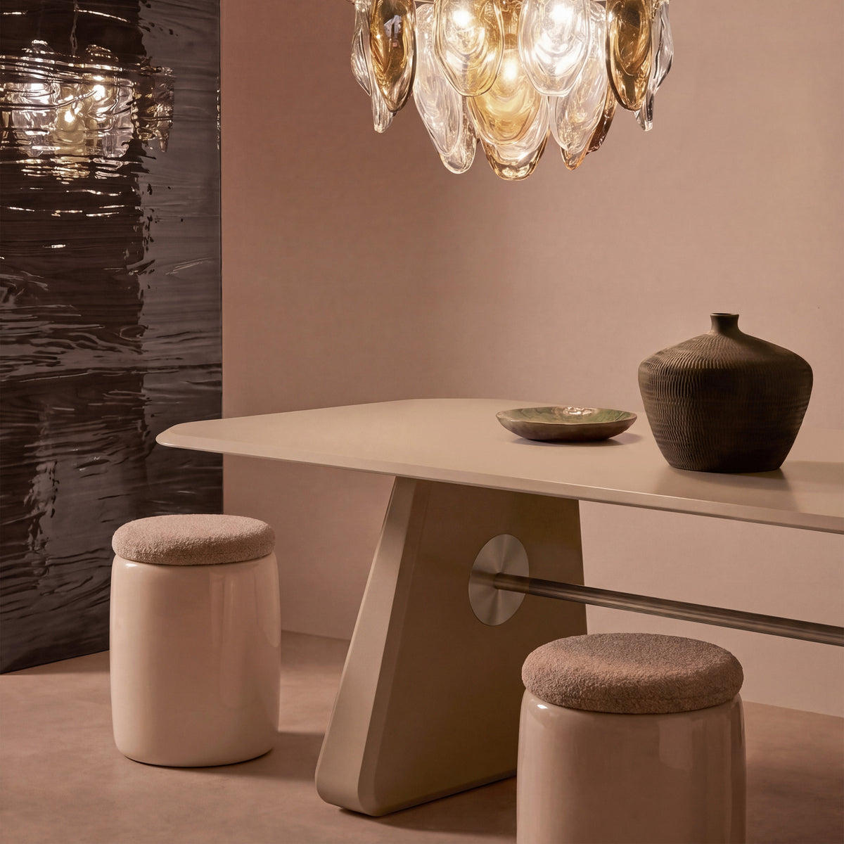 Inge Dining Table in beige styled with a vase under a glass chandelier