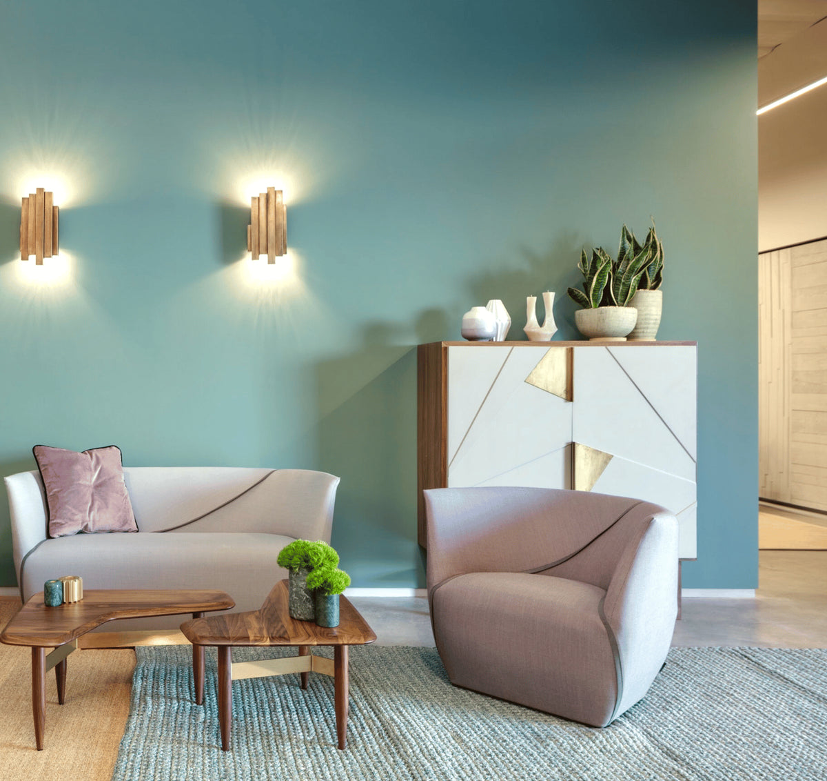 Jazz Bar Cabinet in a teal living room with brass wall lights and a curved sofa