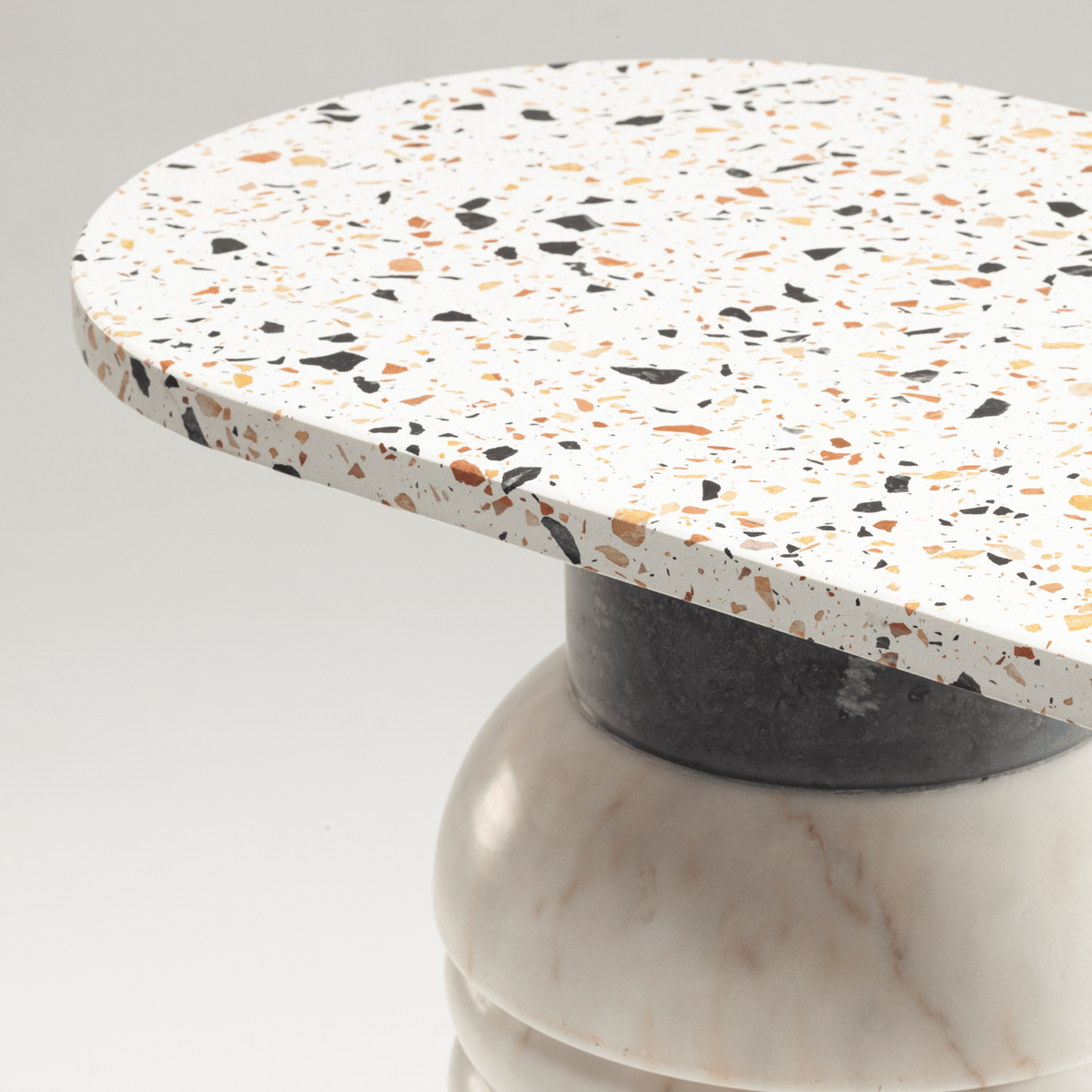 Jean Console Table, close-up of the terrazzo top on a Nero Marquina and marble column