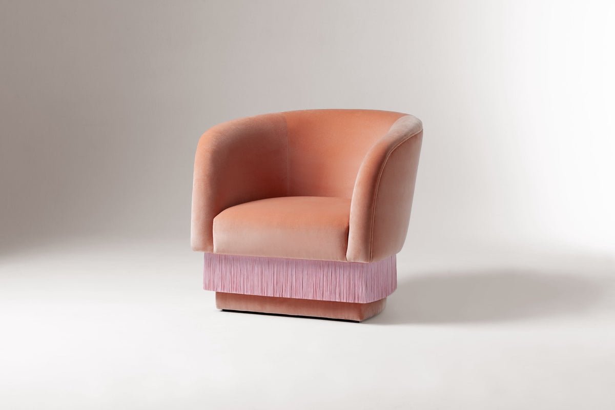 La Folie Armchair in pink velvet with pink fringe skirt, three-quarter view