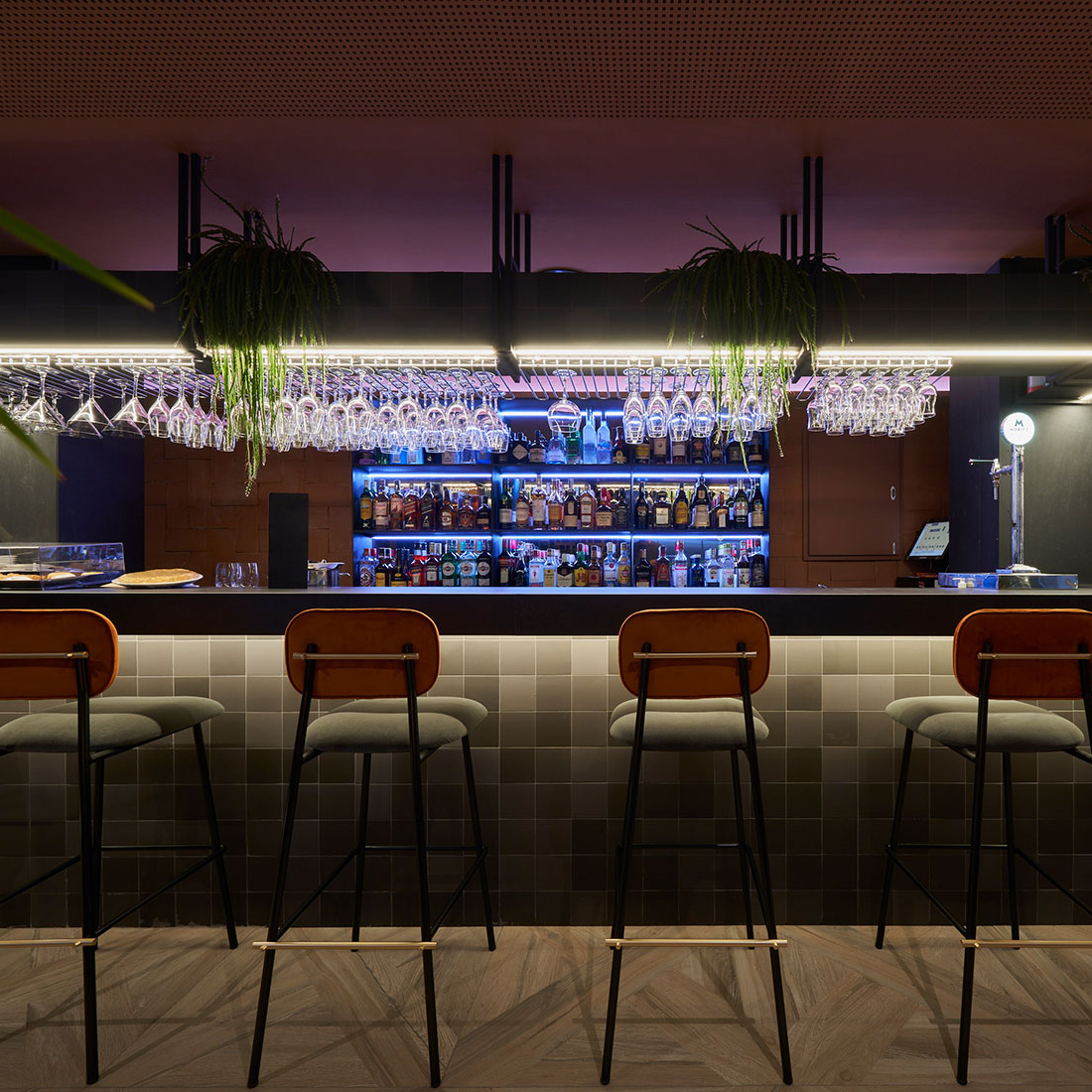 Miami Counter Stool set with wood backs at a dark cocktail bar