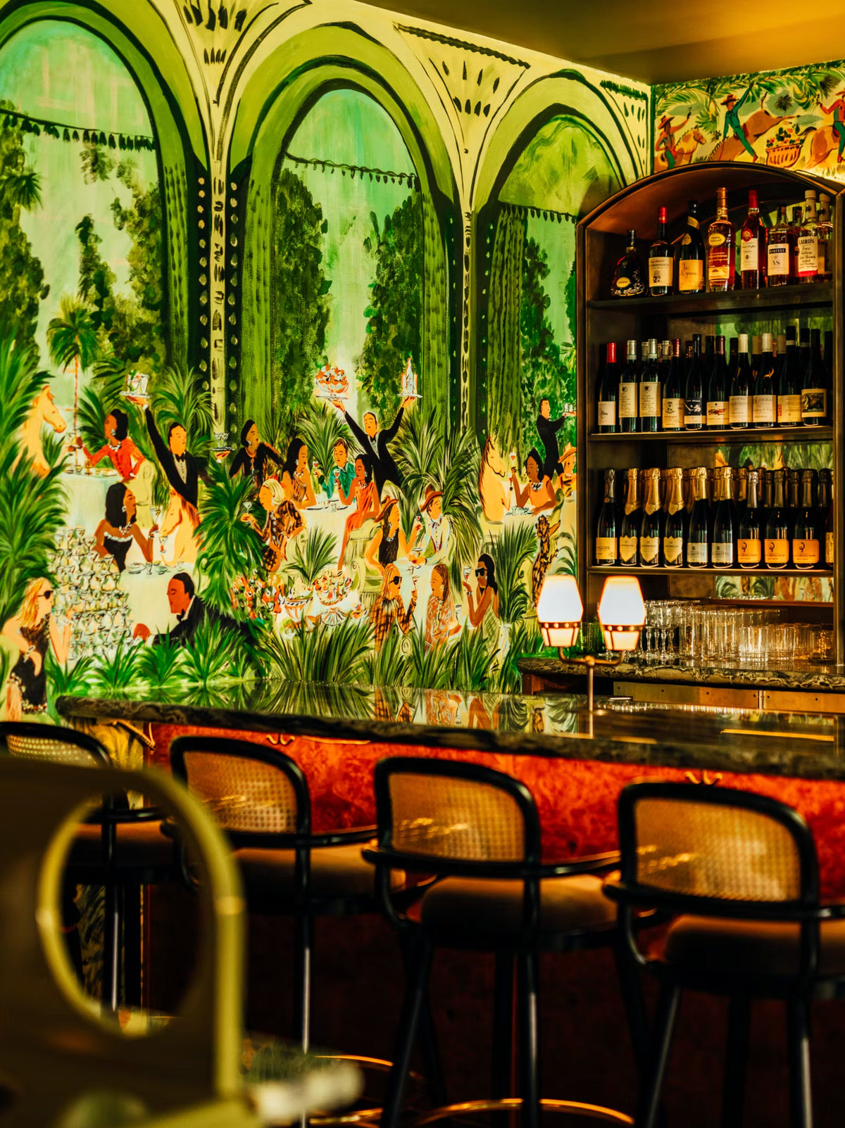 Luc bar chairs at a restaurant bar with a tropical mural