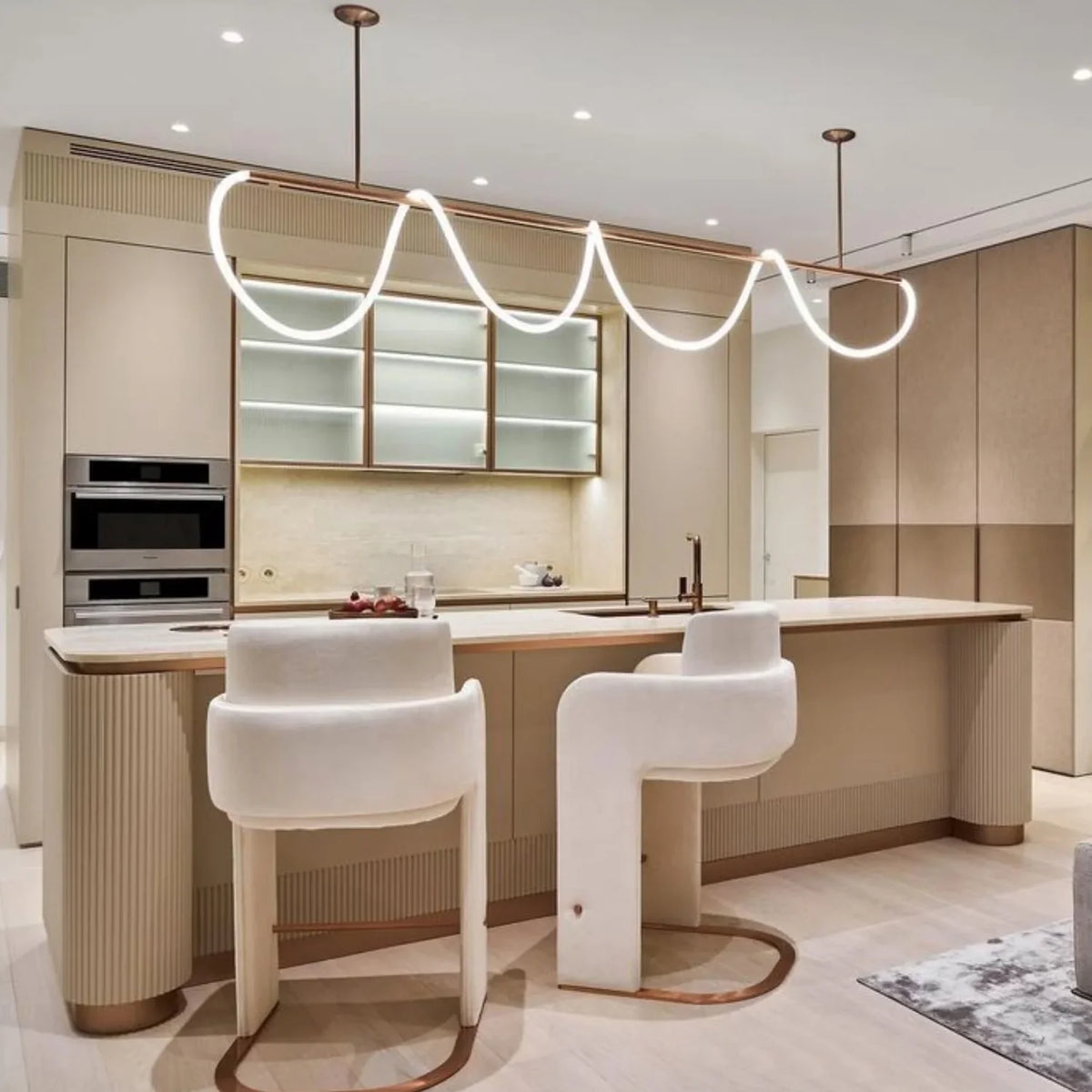 Kitchen with white counter stools by Maison Burgos