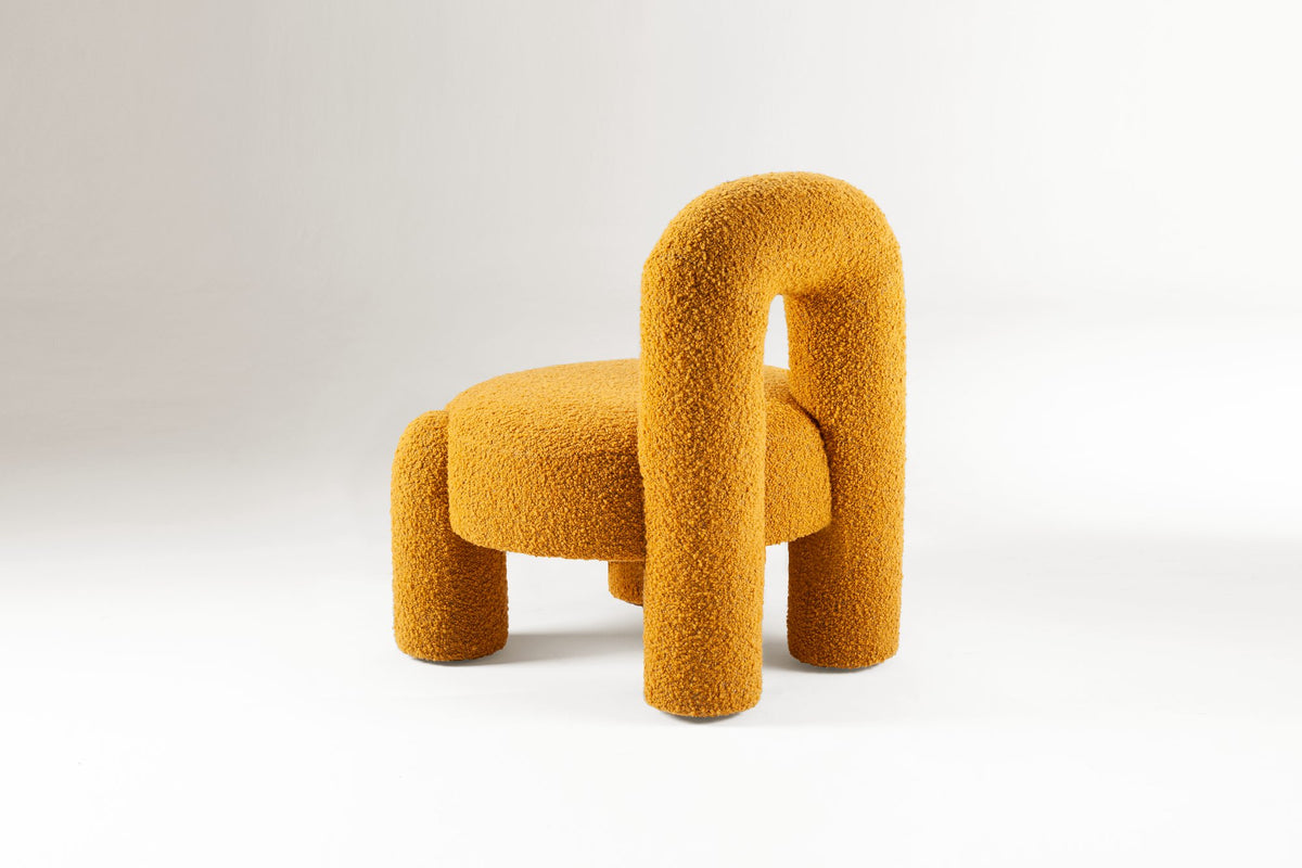 Marlon Armchair in mustard bouclé, side three-quarter view
