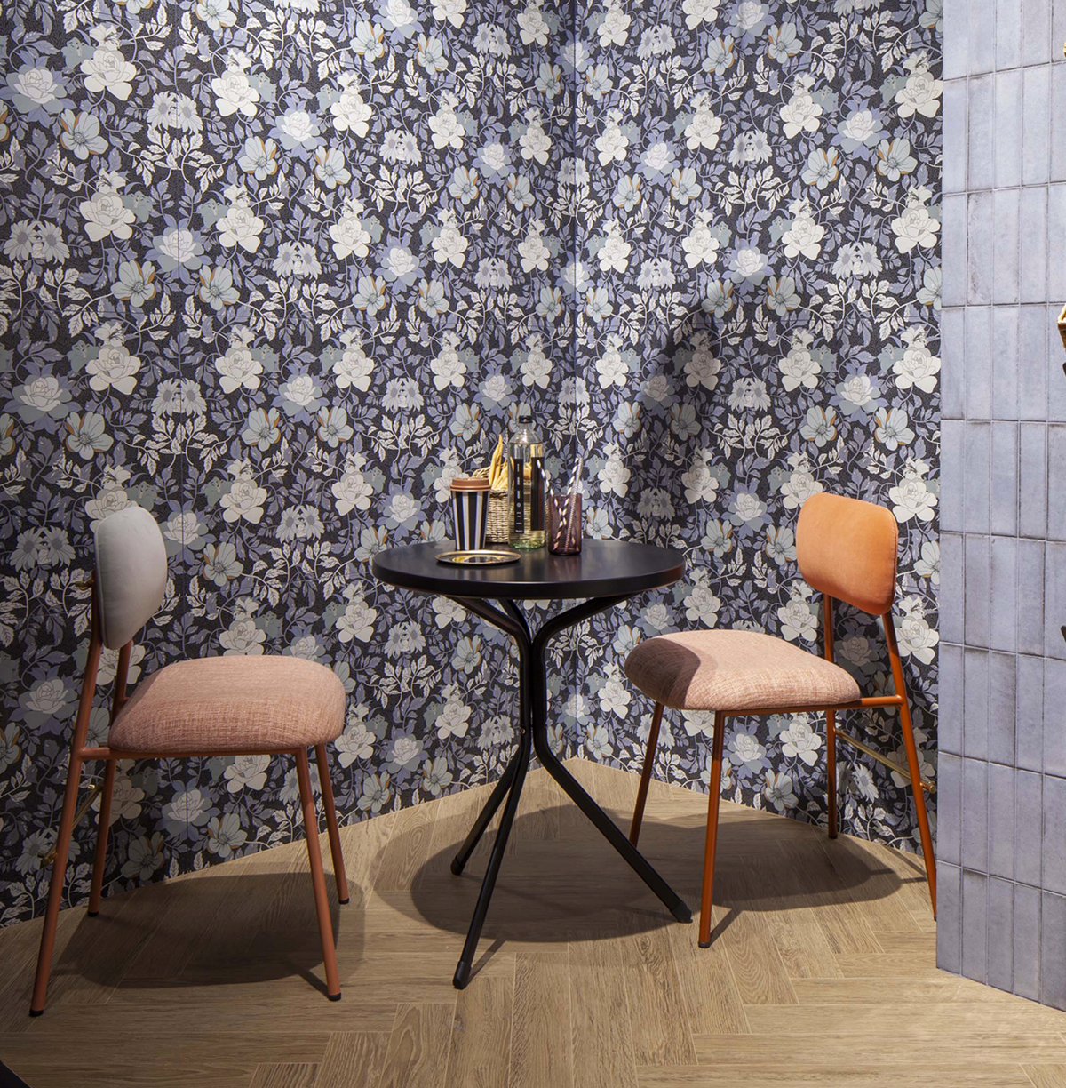 Miami Dining Chairs in pink and coral at a small black bistro table against floral wallpaper