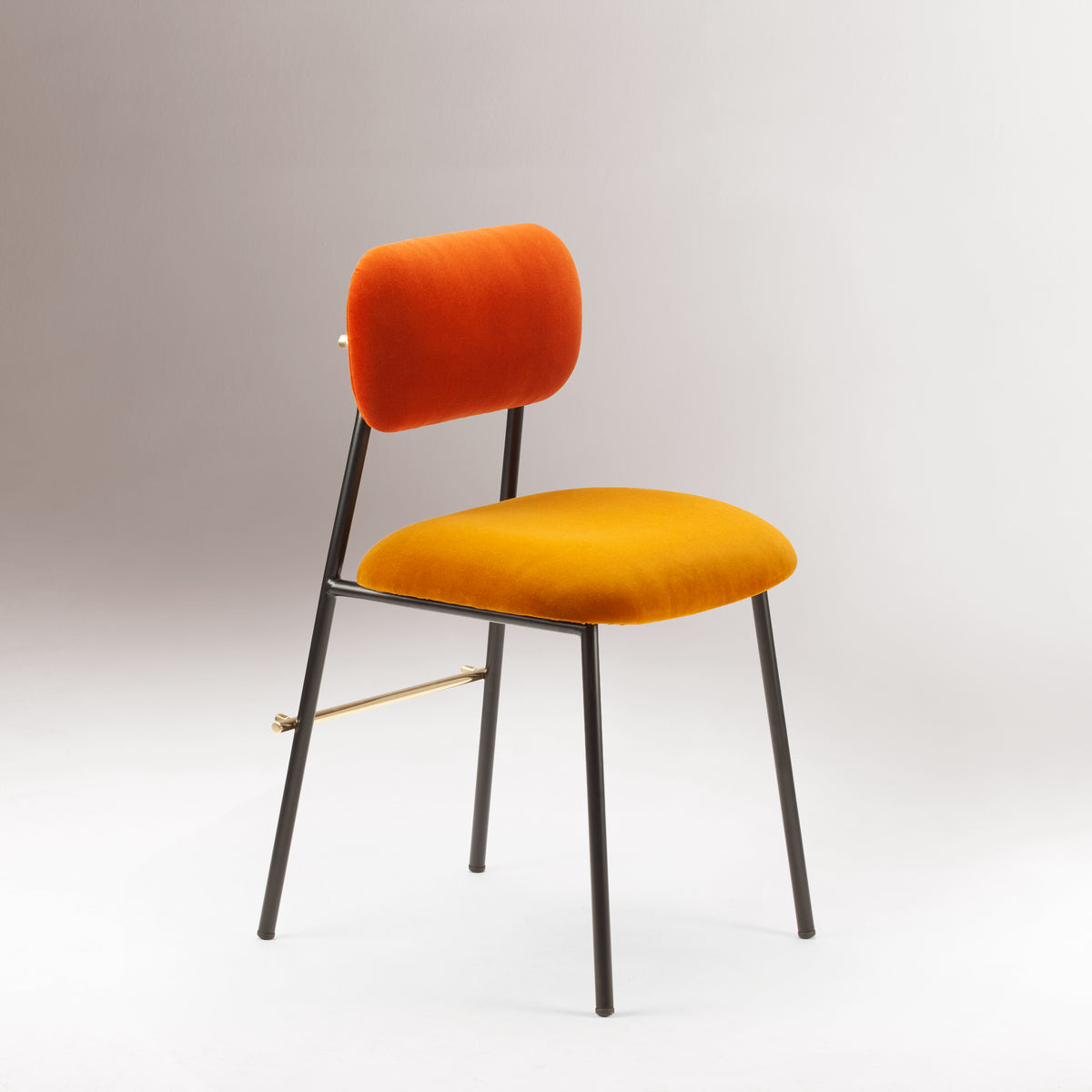 Miami Dining Chair with orange back and mustard velvet seat on a grey backdrop