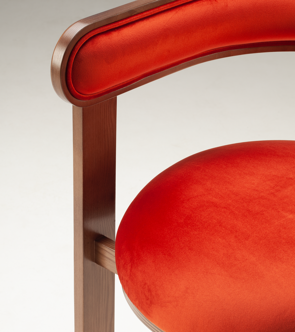 Moulin Dining Chair, close-up of the orange velvet seat and curved walnut-tone backrest