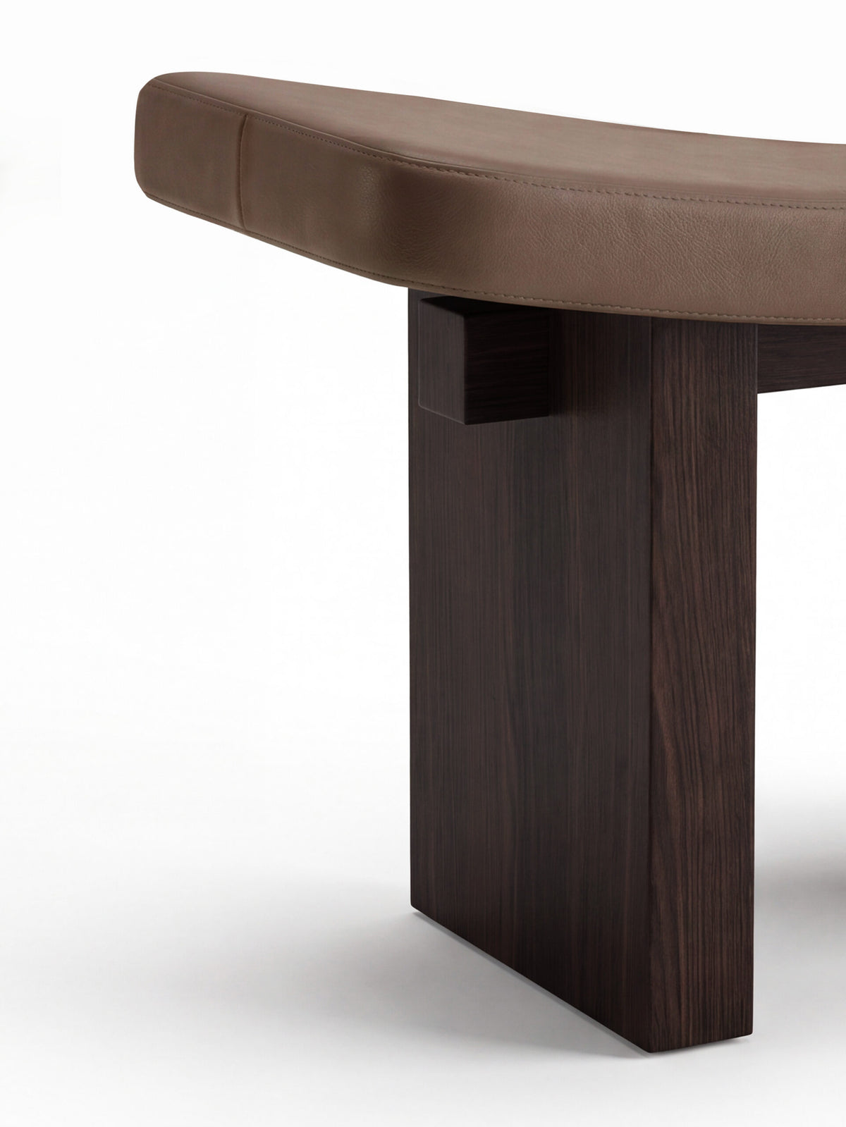Nara Ottoman close-up of the brown leather seat and dark wood leg joint