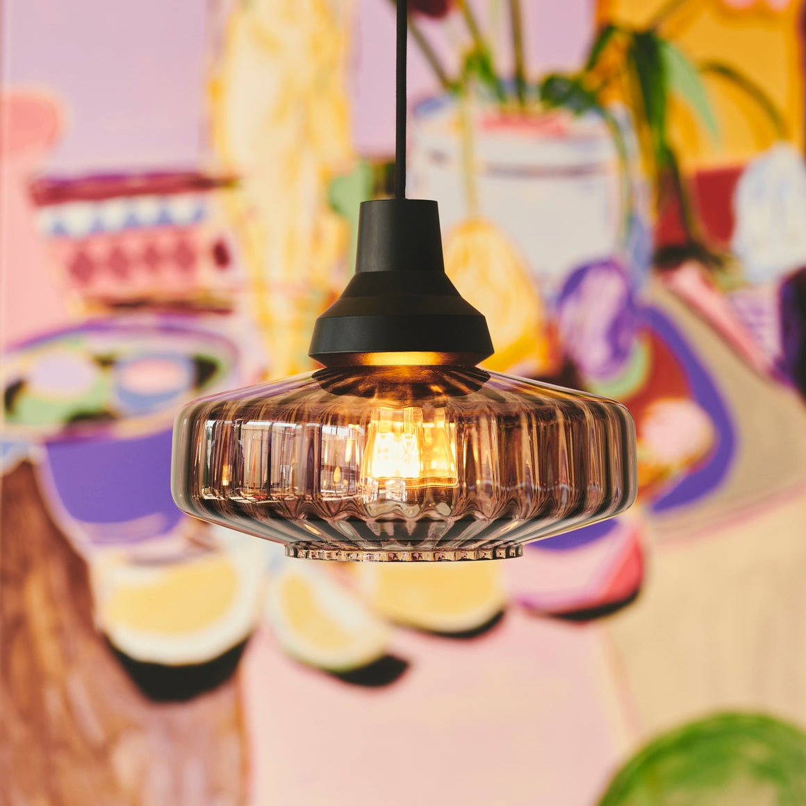 New Wave Optic Pendant Light in Smoke glass with black canopy, lit close-up
