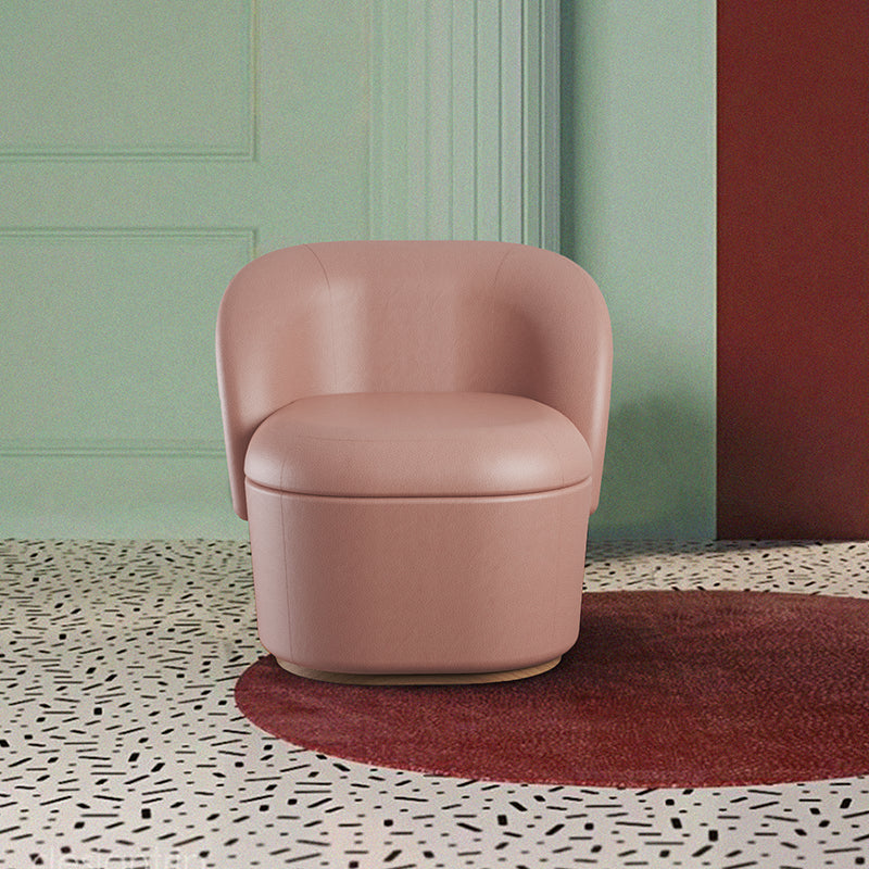 Bisou Armchair in blush pink on a terrazzo floor with a red rug