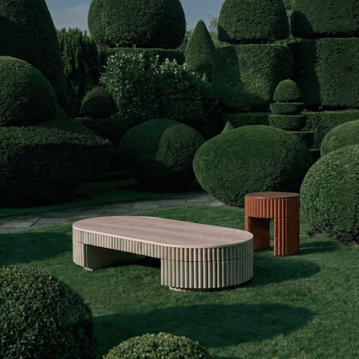 Nouvelle Vague Center Table in travertine on a lawn among topiary hedges