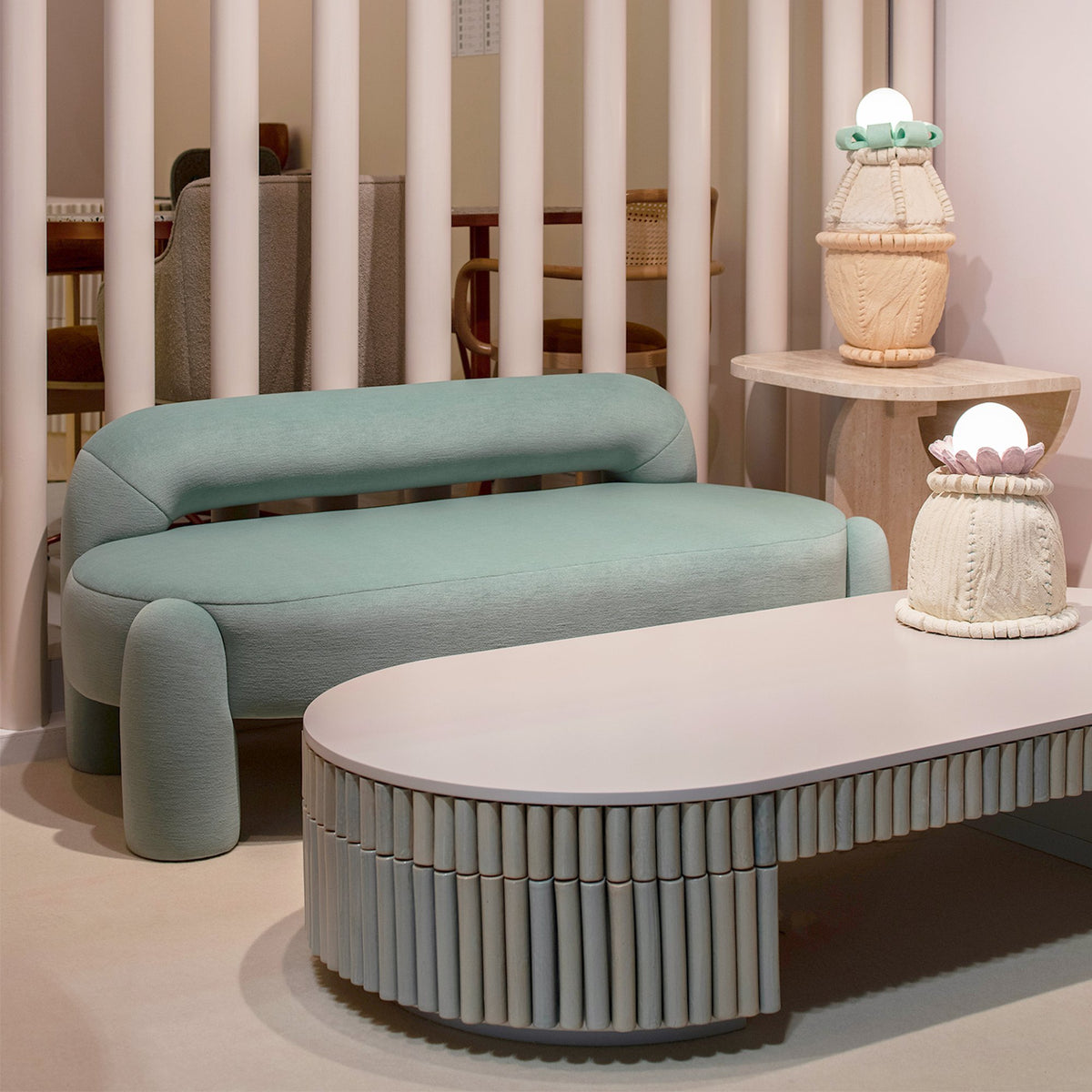 Nouvelle Vague Center Table in jade beside a mint daybed in a pink room