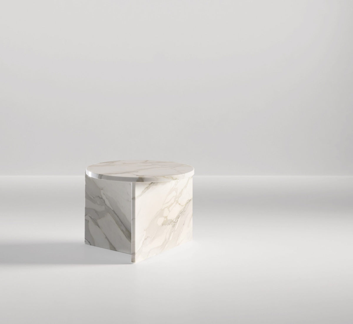 Origin Side Table in white marble with grey veining on a pale backdrop