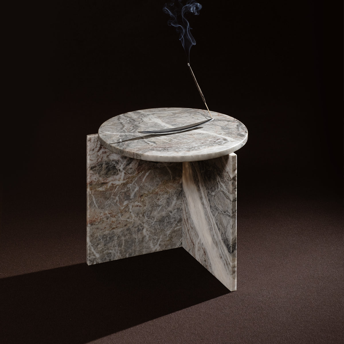 Origin Side Table in grey marble with incense on a dark backdrop