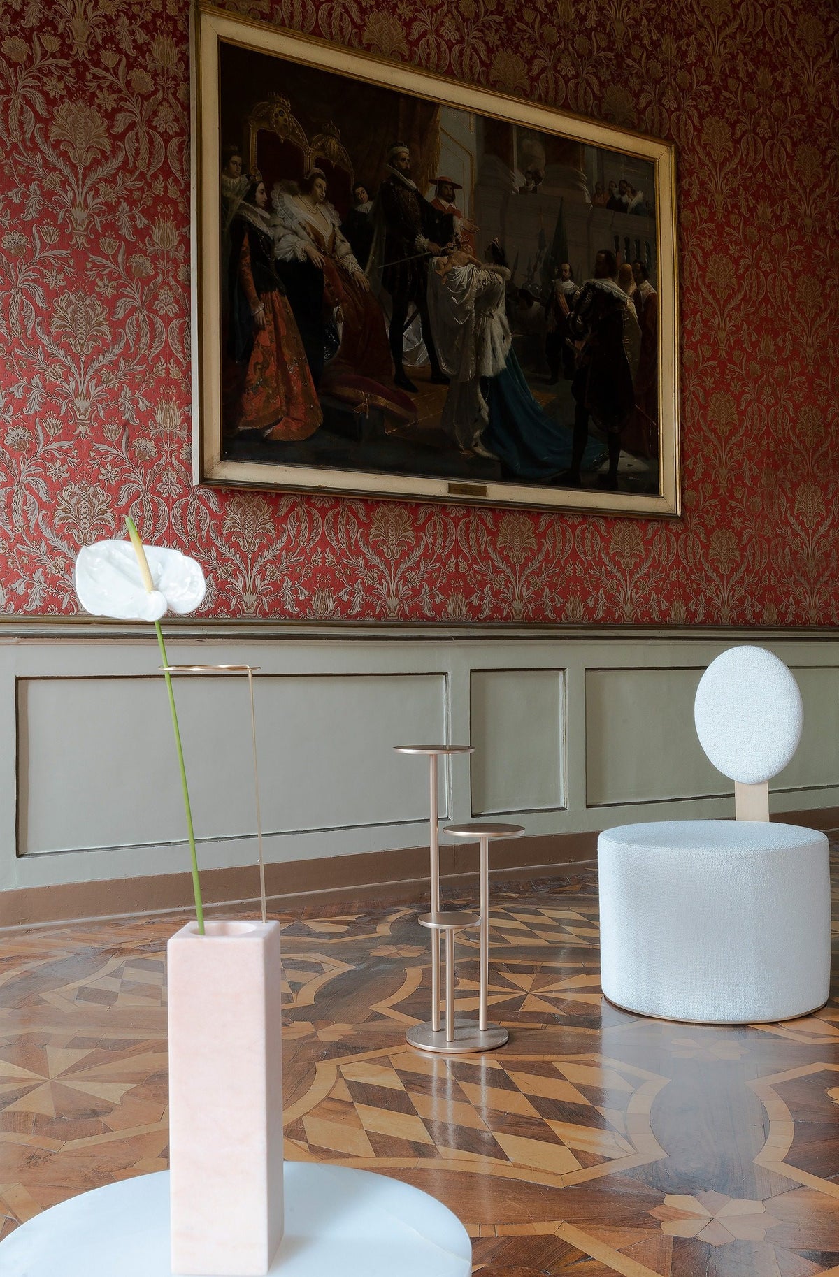Orion Side Table in a palace hall with parquet floor and white chair