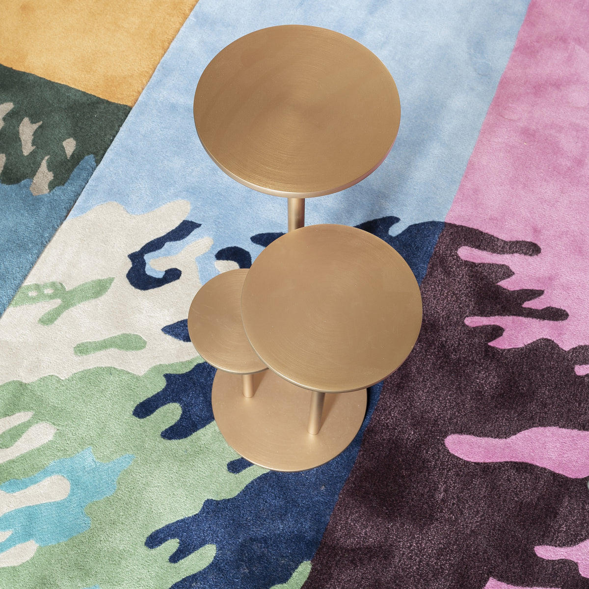Orion Side Table in Satin Brass, close top view of tiered discs on a rug