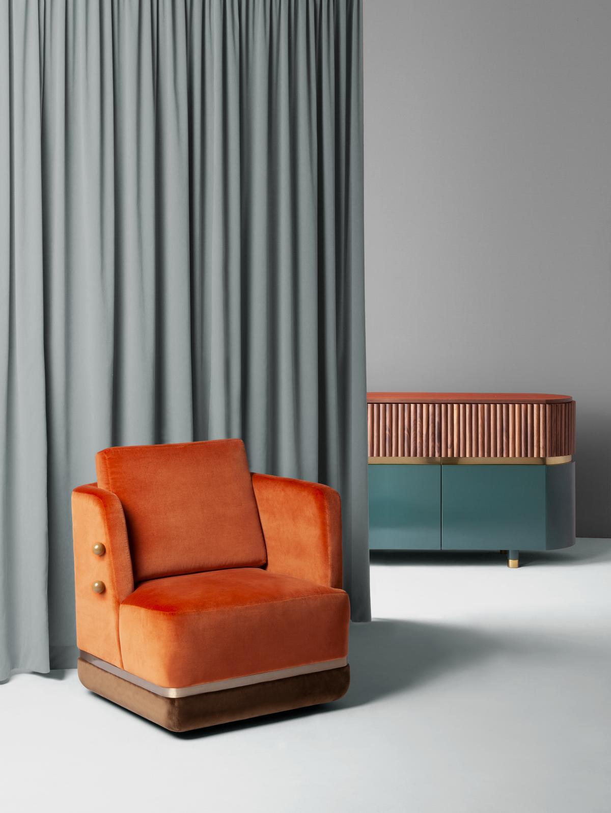 Panorama Armchair in orange velvet beside sage curtains and a teal sideboard