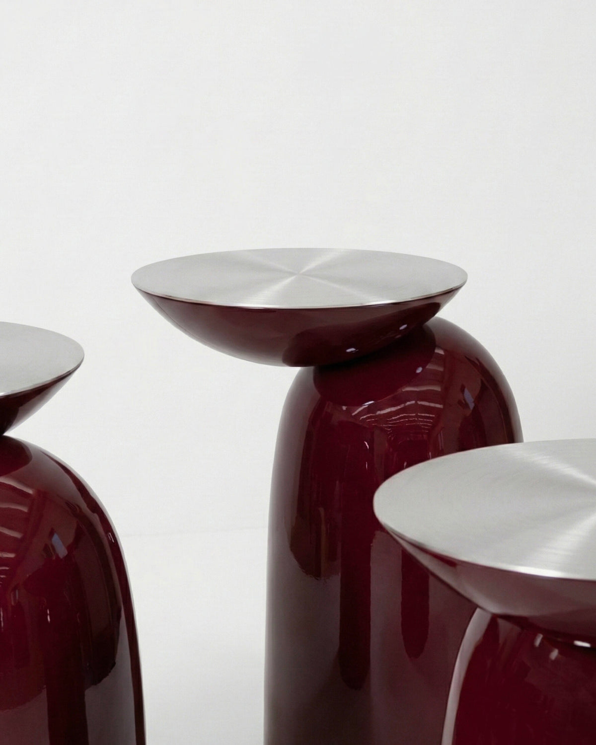 Pingu Side Tables in burgundy high-gloss lacquer with brushed metal tops, close-up group