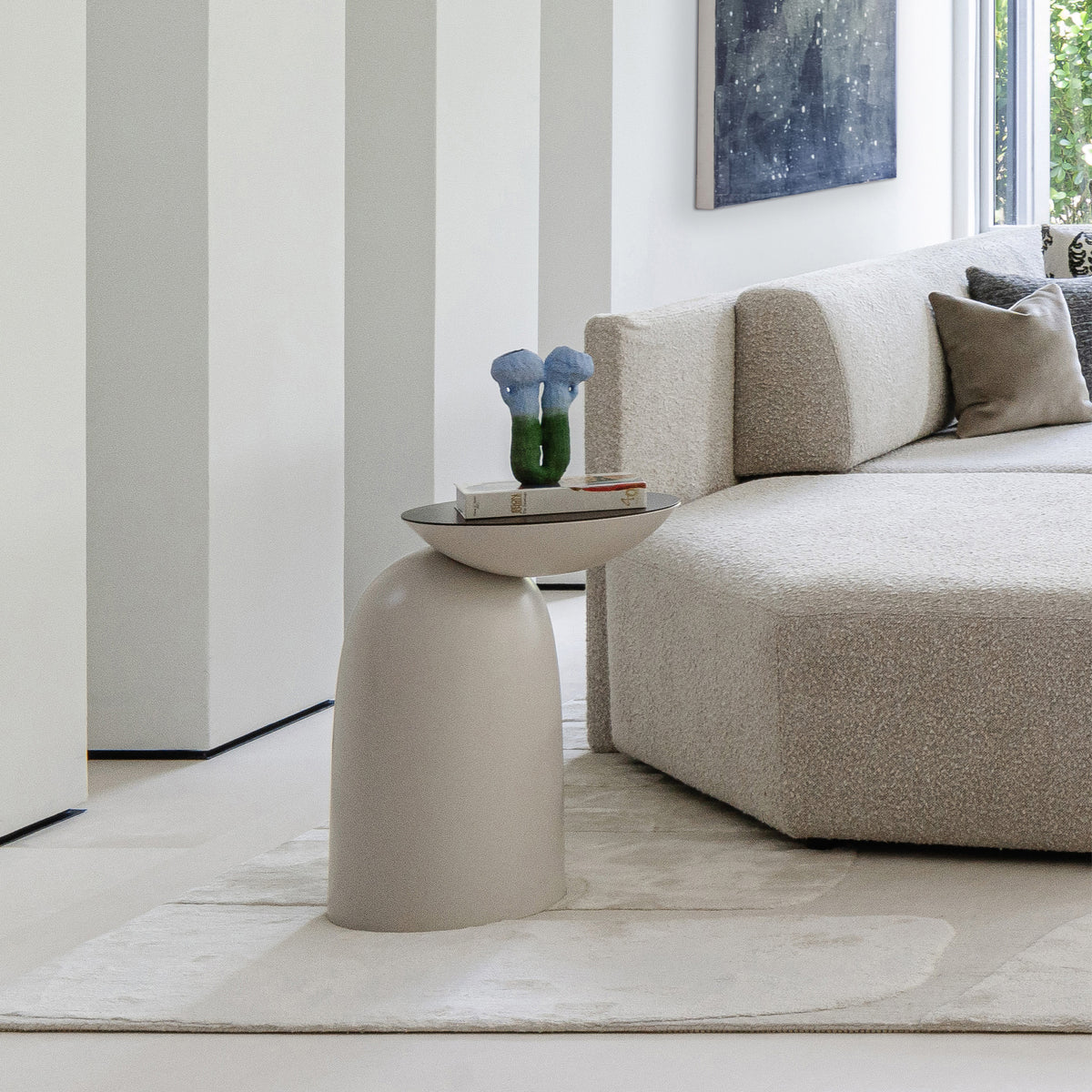 Pingu Side Table in taupe lacquer, left view beside a beige sofa