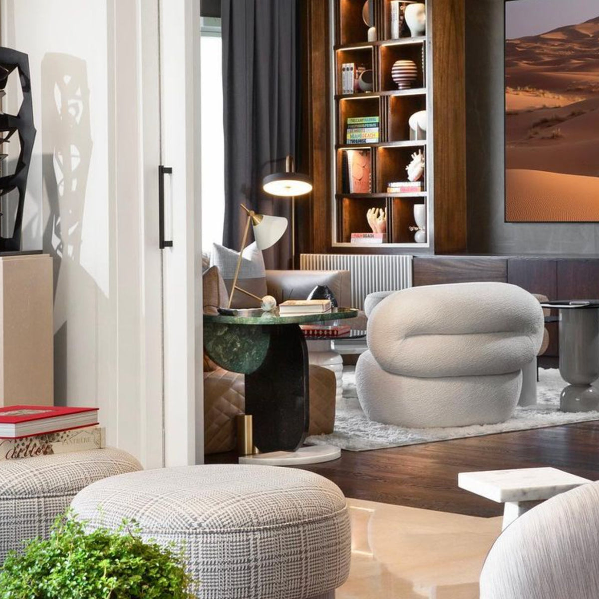 Playing Games Side Table in a living room beside a sculptural armchair