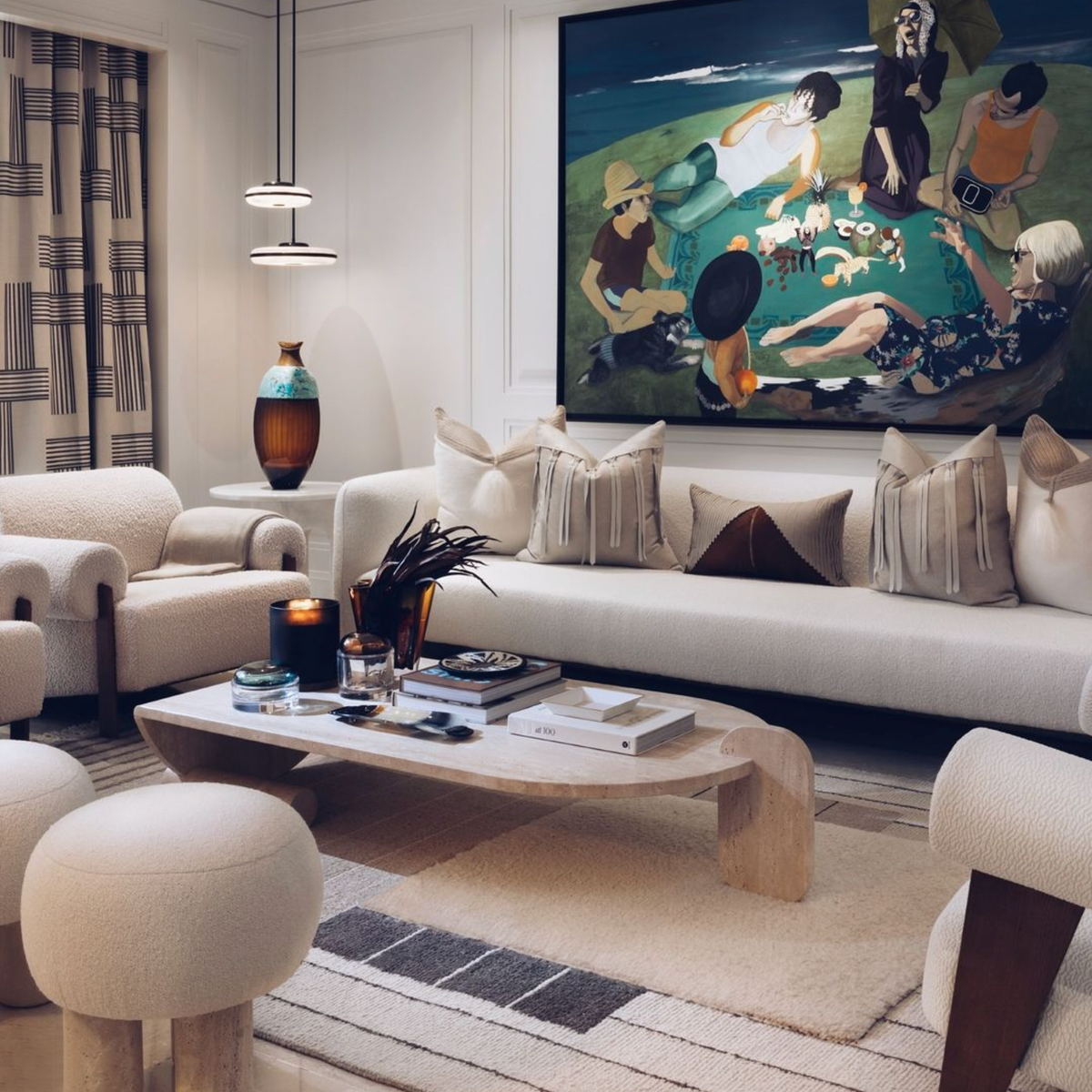 Playing Games Travertine Coffee Table before a cream sofa beneath a large figurative painting