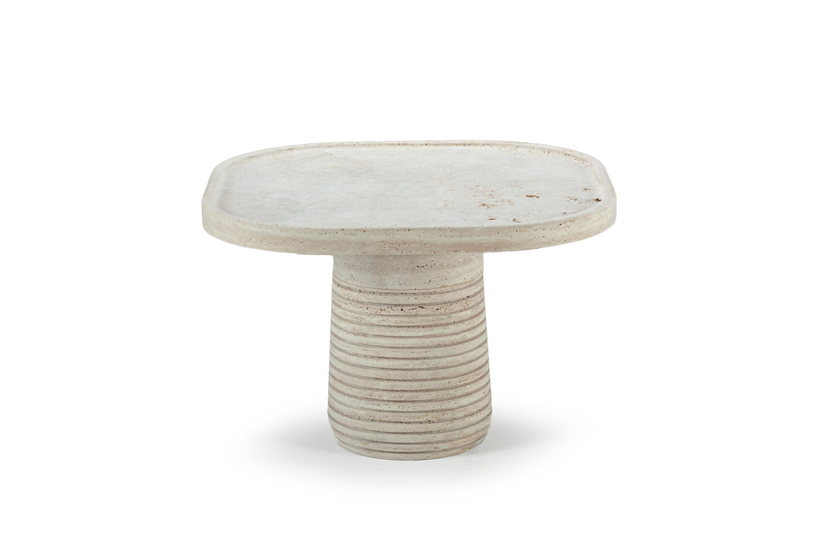 Poppy Side Table in travertine with ribbed base, three-quarter view on white
