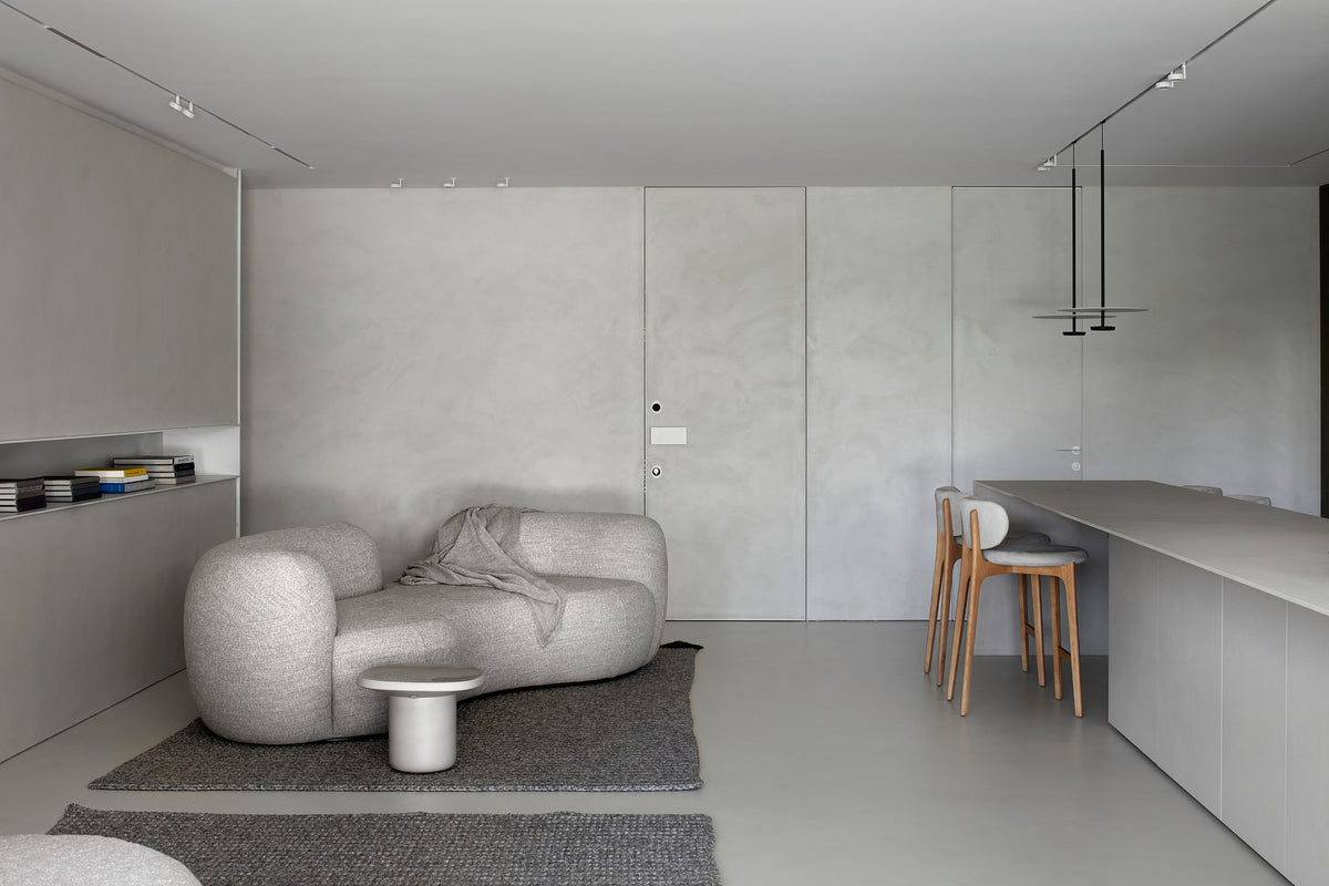Richmond Bar Stools at a counter in an open living space with a bouclé sofa