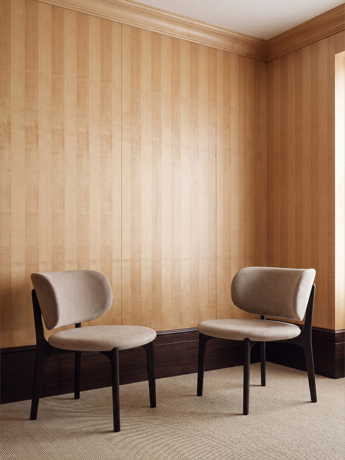 Richmond Lounge Chair pair in a wood-paneled room