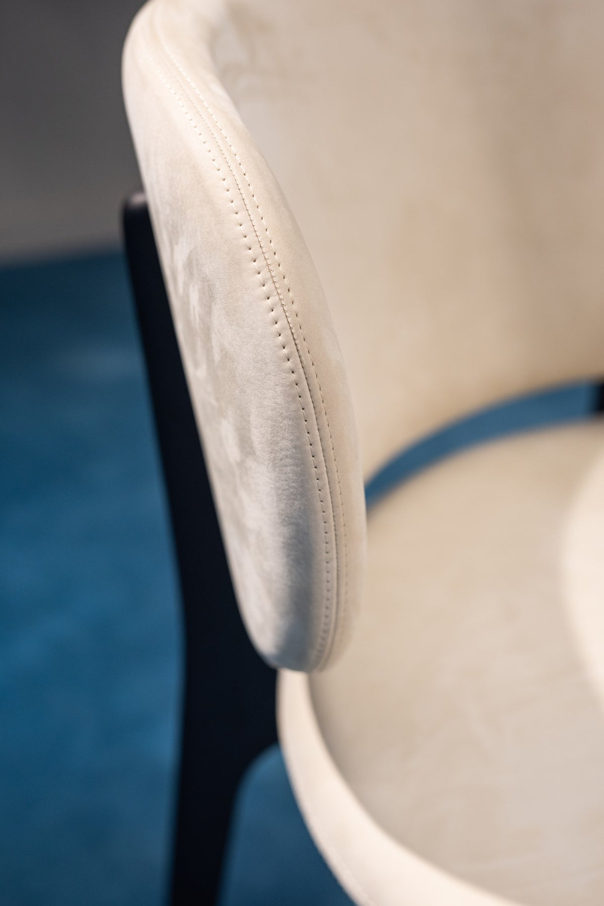 Richmond Lounge Chair detail of upholstered back over a blue floor