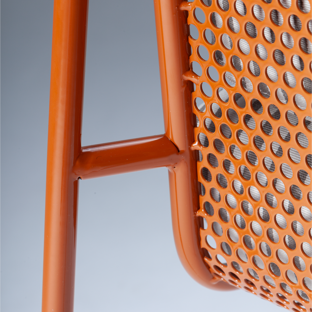 Riviera Chair detail of orange perforated metal back and frame