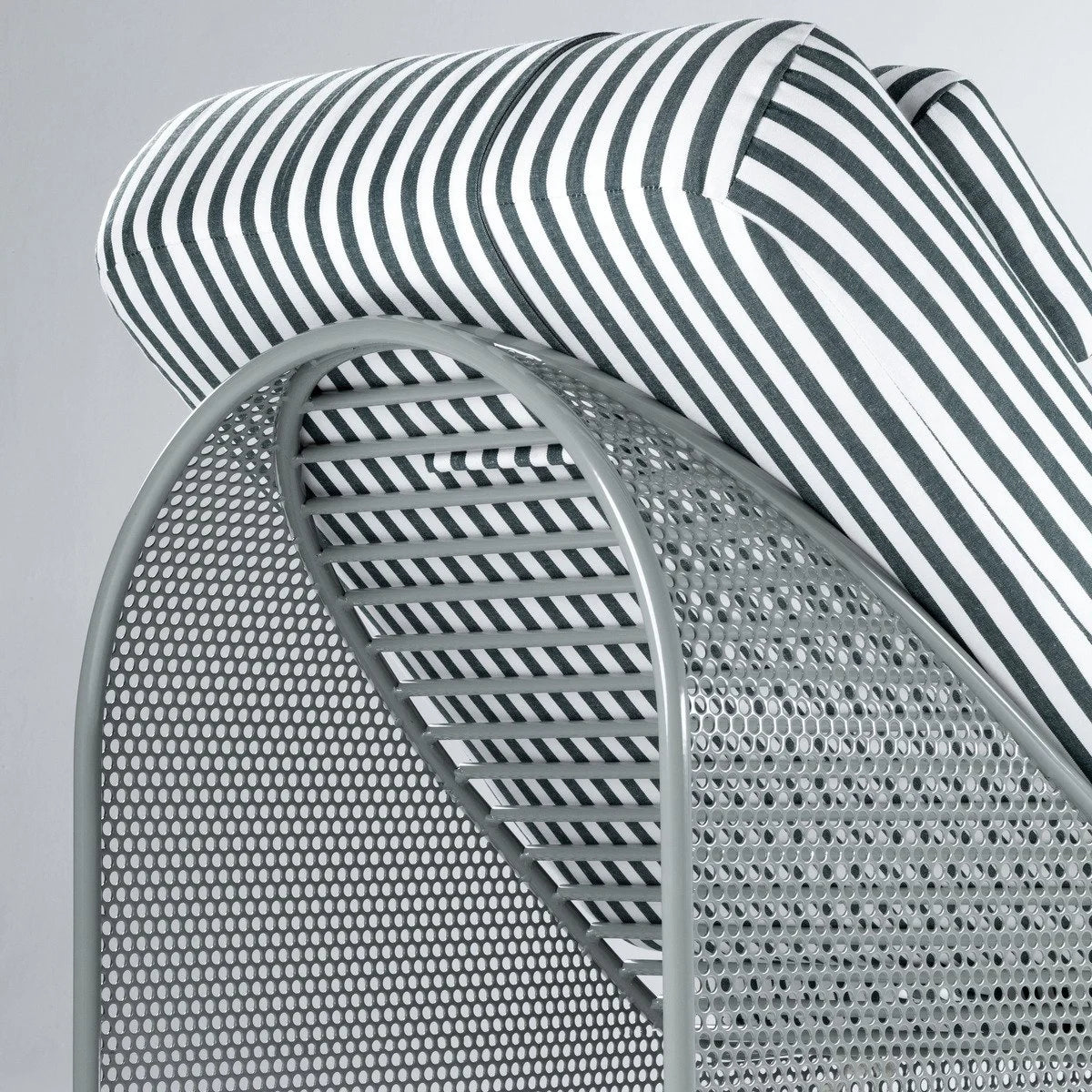 Riviera Daybed close-up of the striped cushion and perforated metal back
