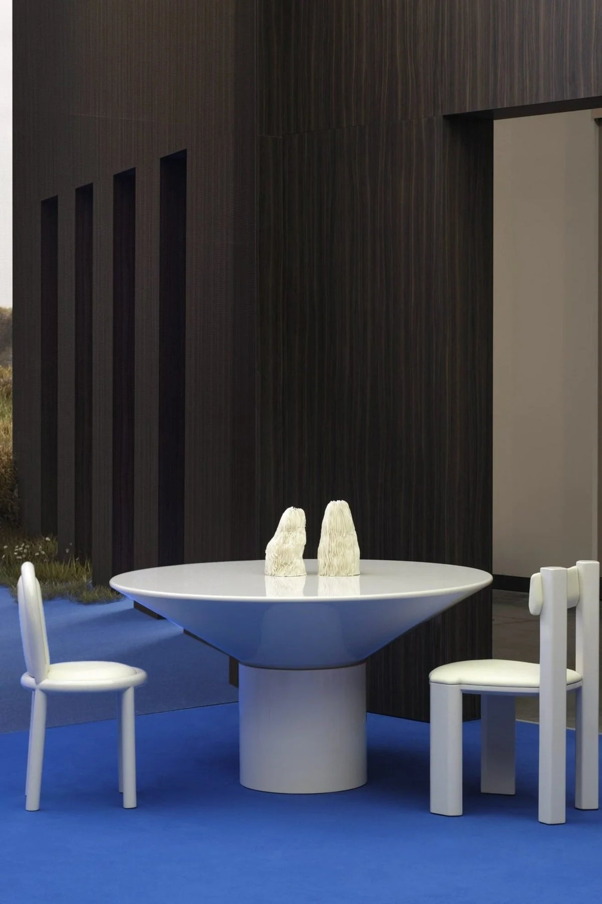 Silo Dining Table in white lacquer with white chairs on a blue floor